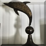 D92. Metal etched dolphin on a ball. 13”h - $24 